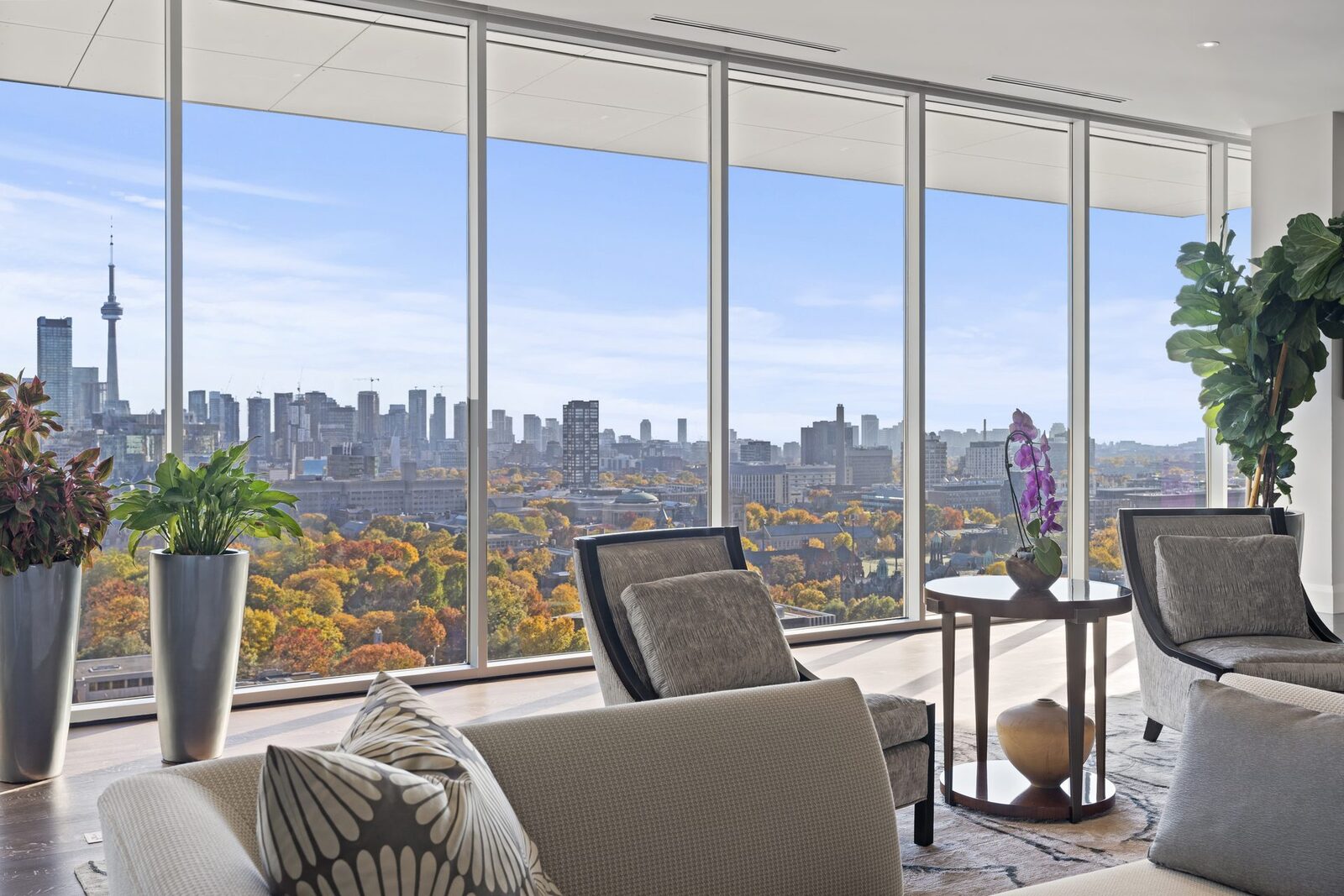 Modern penthouse living room with floor-to-ceiling glass and the Toronto skyline