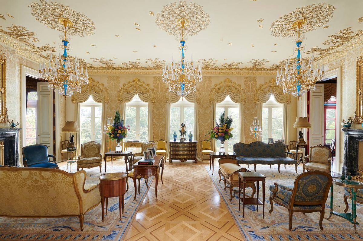 Gilded grand salon at 15 Highpoint with chandeliers and arched windows