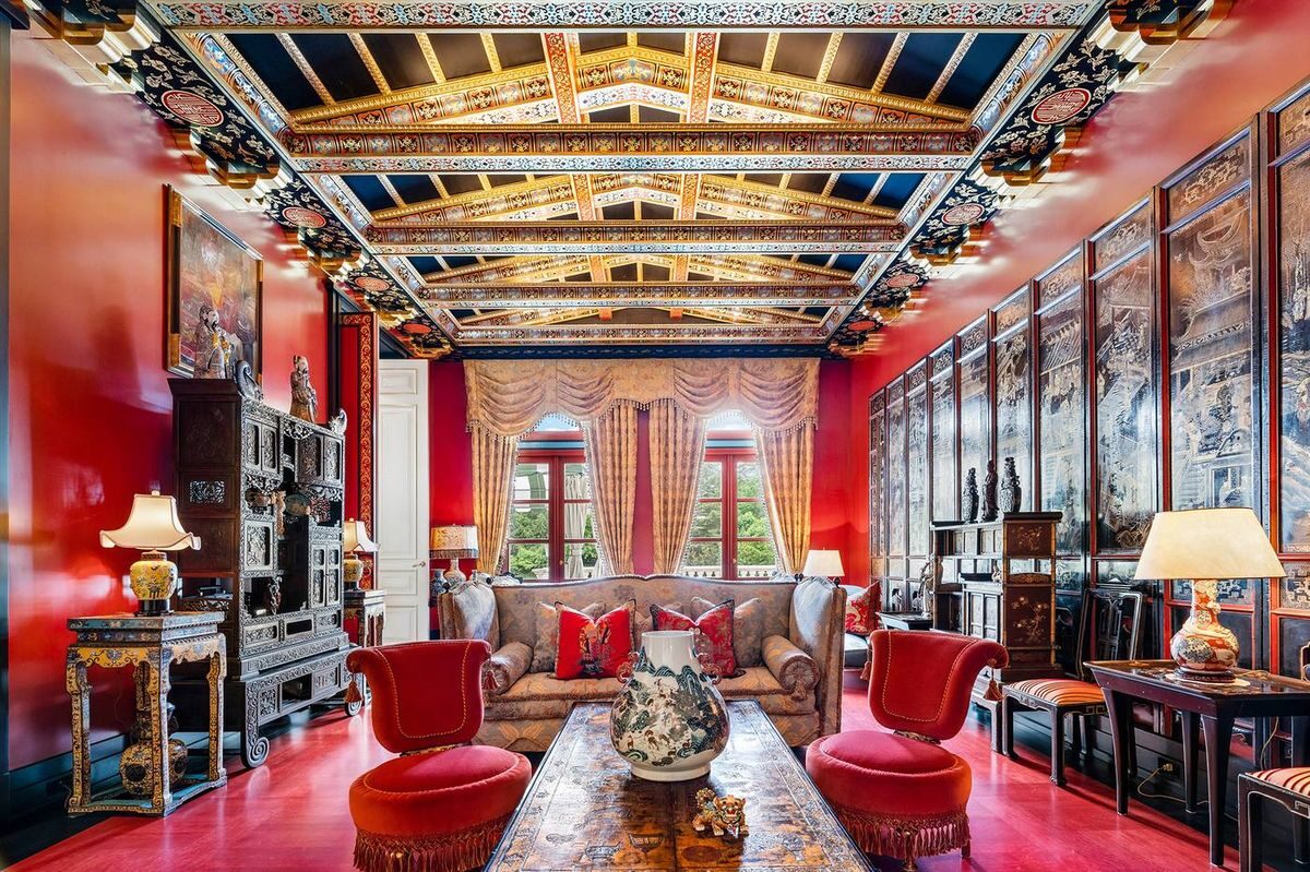 Dramatic red lacquered room with ornate coffered ceiling
