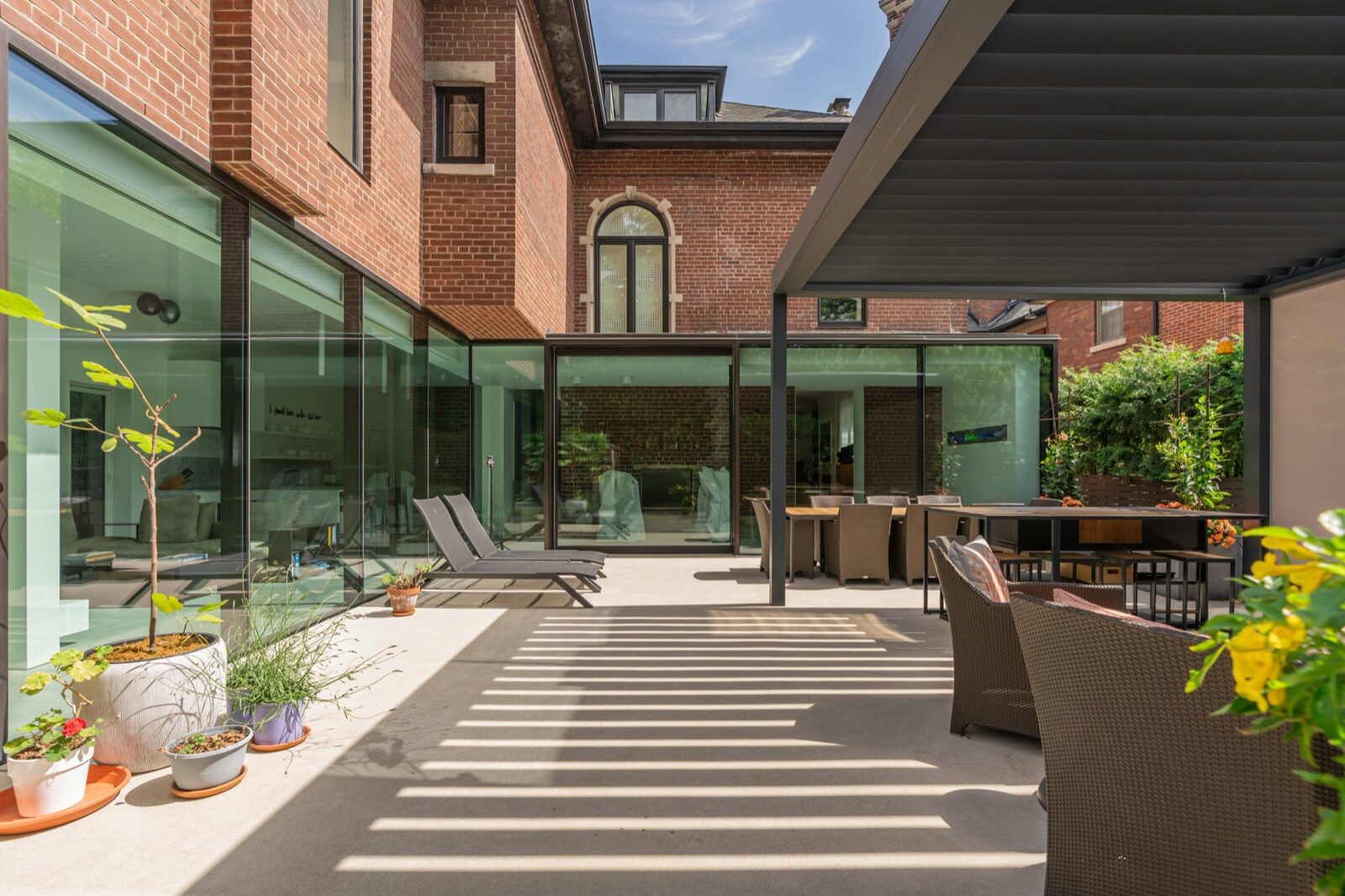 Glass and brick courtyard of a renovated heritage residence
